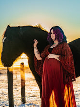 Load image into Gallery viewer, Pregnant person posing with the sun setting in the background. Silhouette of bump and body through the gown. Lace Chocolate Brown Maternity Photoshoot Pregnancy. Horse
