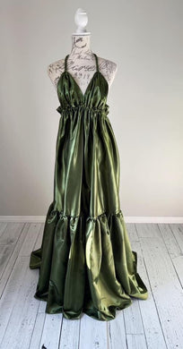 An olive halter top maternity photoshoot gown. You can rent or buy this dress for your pregnancy.